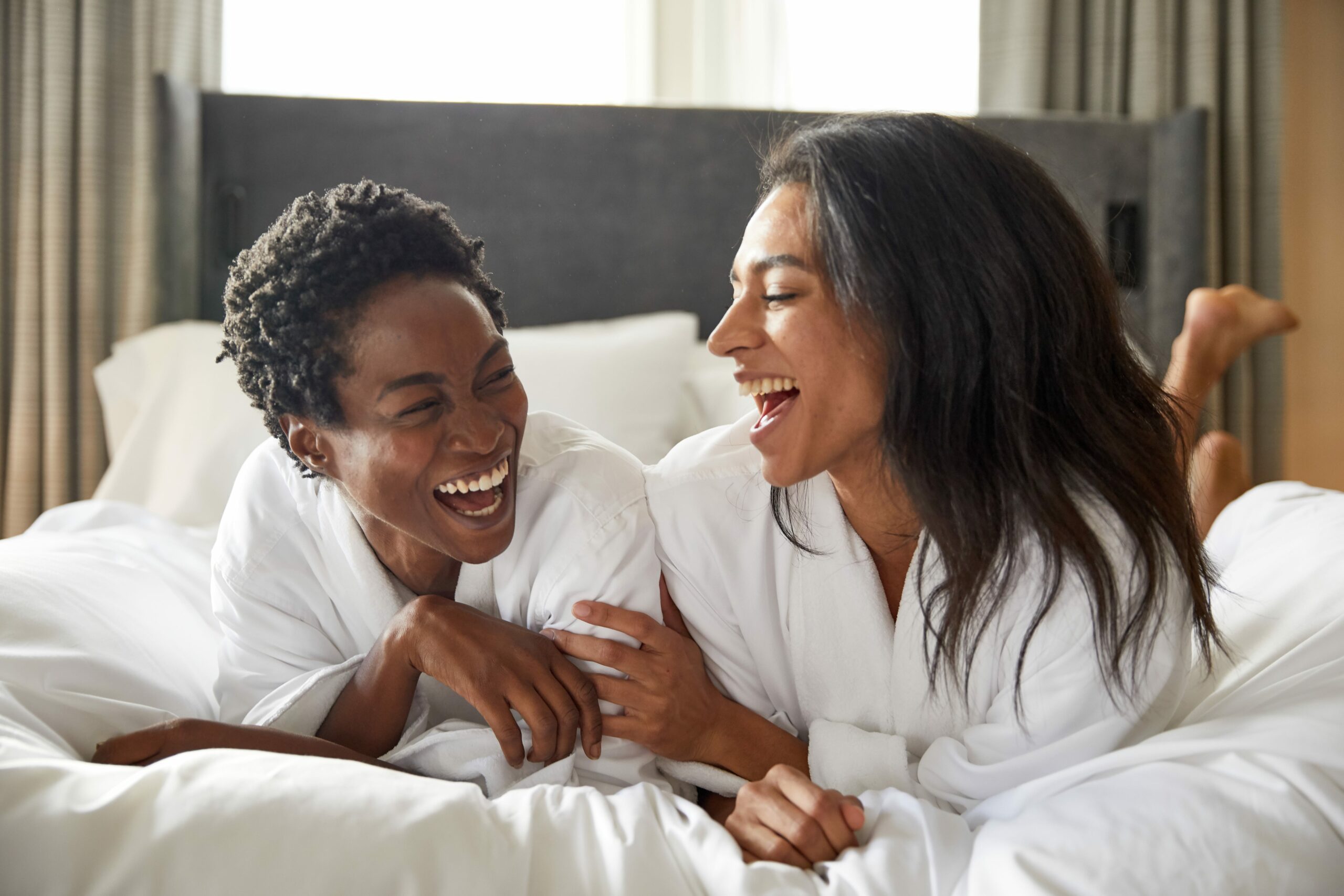 two people in robes laughing