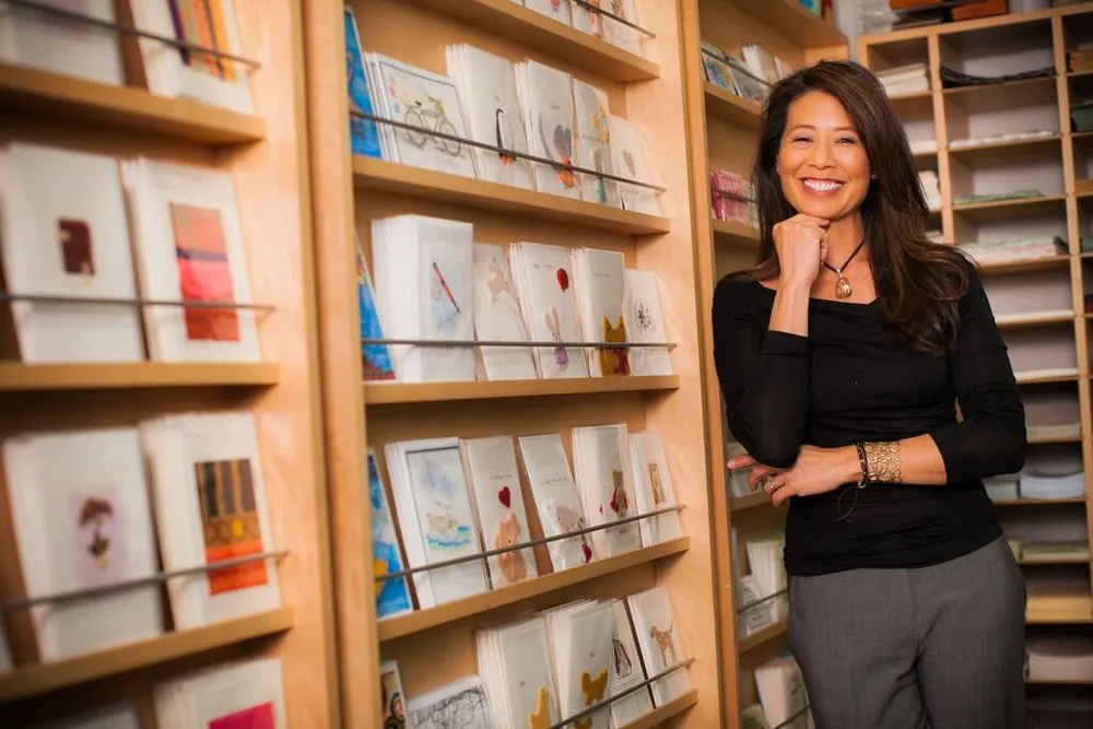 person standing beside card displays