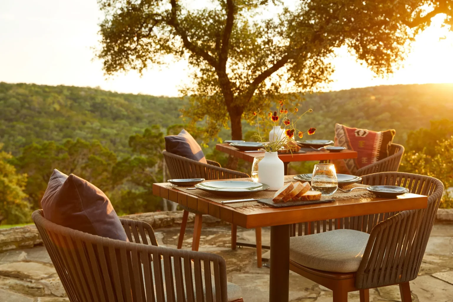 Outdoor dining terrace at sunset overlooking the Hill Country