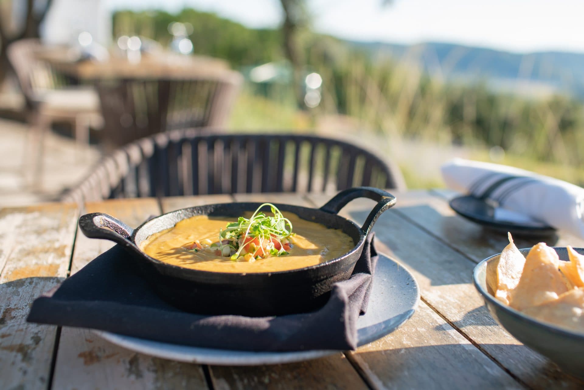 vegan queso and chips on a table
