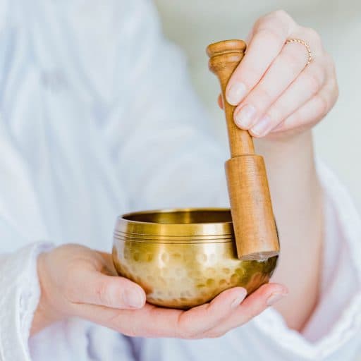 person holding sound bowl