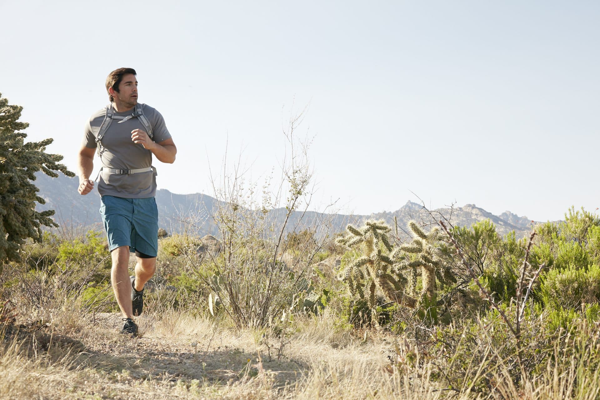 person wearing a backpack running outside