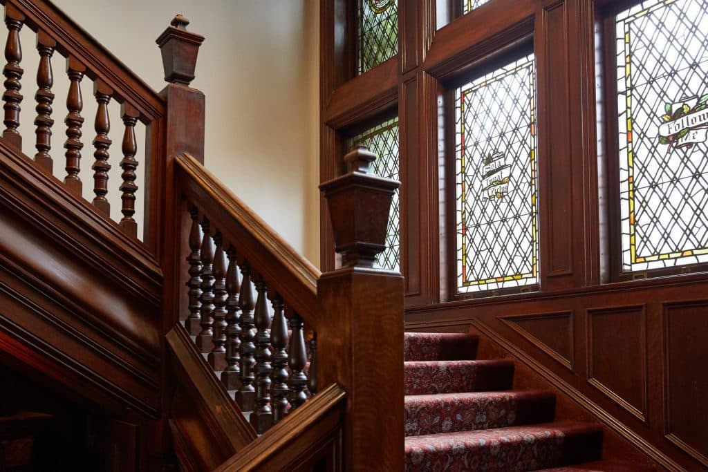 Stairs and beautiful antique windows with colourful glass at mansion