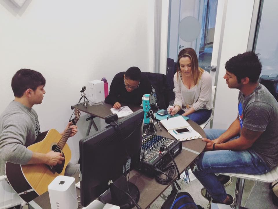 A group of friends making music together in studio